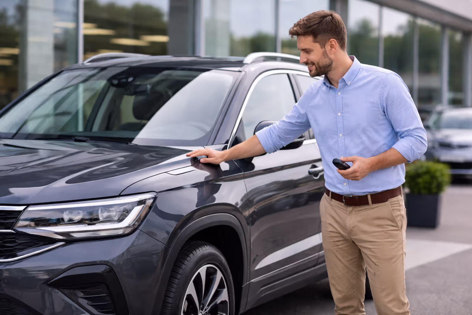 Person with new SUV at dealership after purchase
