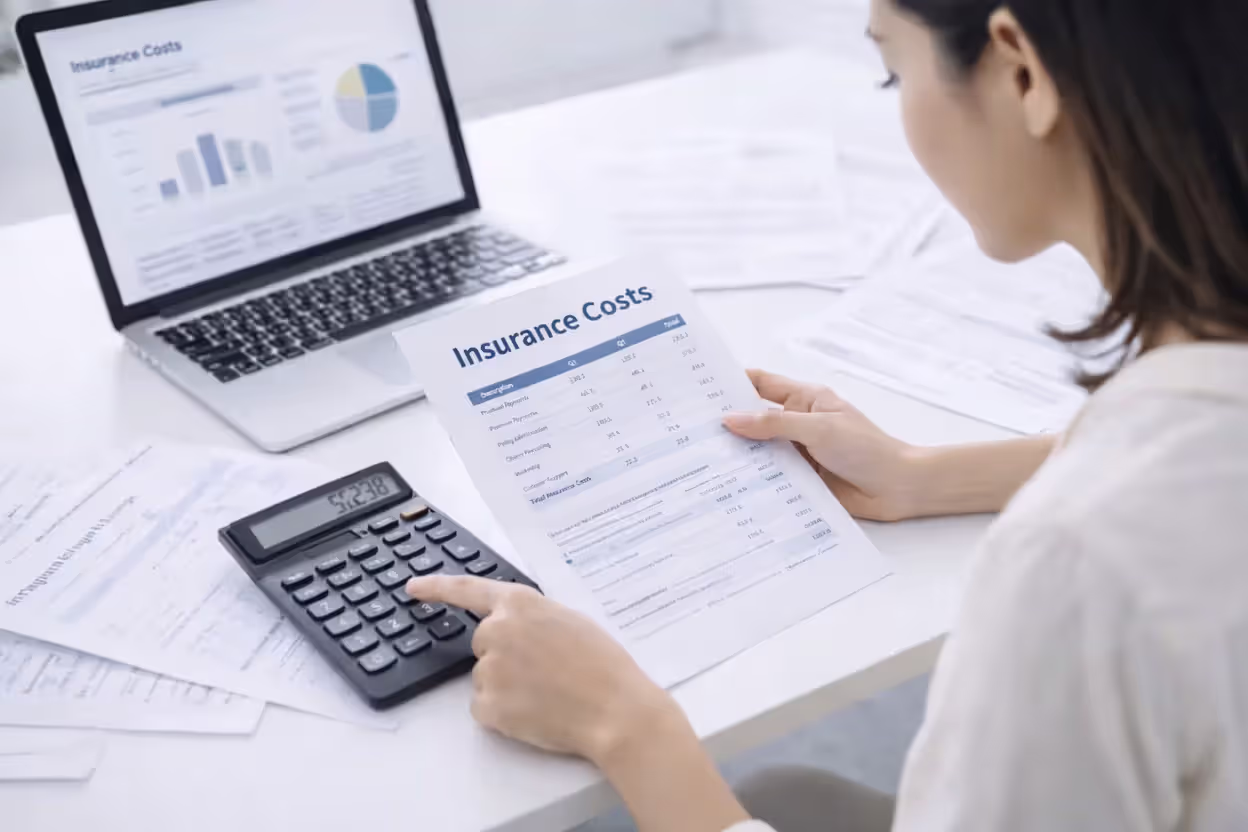 person calculating insurance premium and expenses